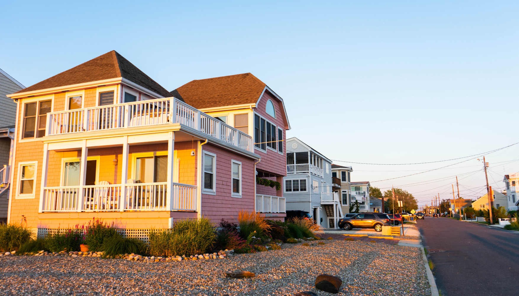 A row of houses are lined up on the side of a road.