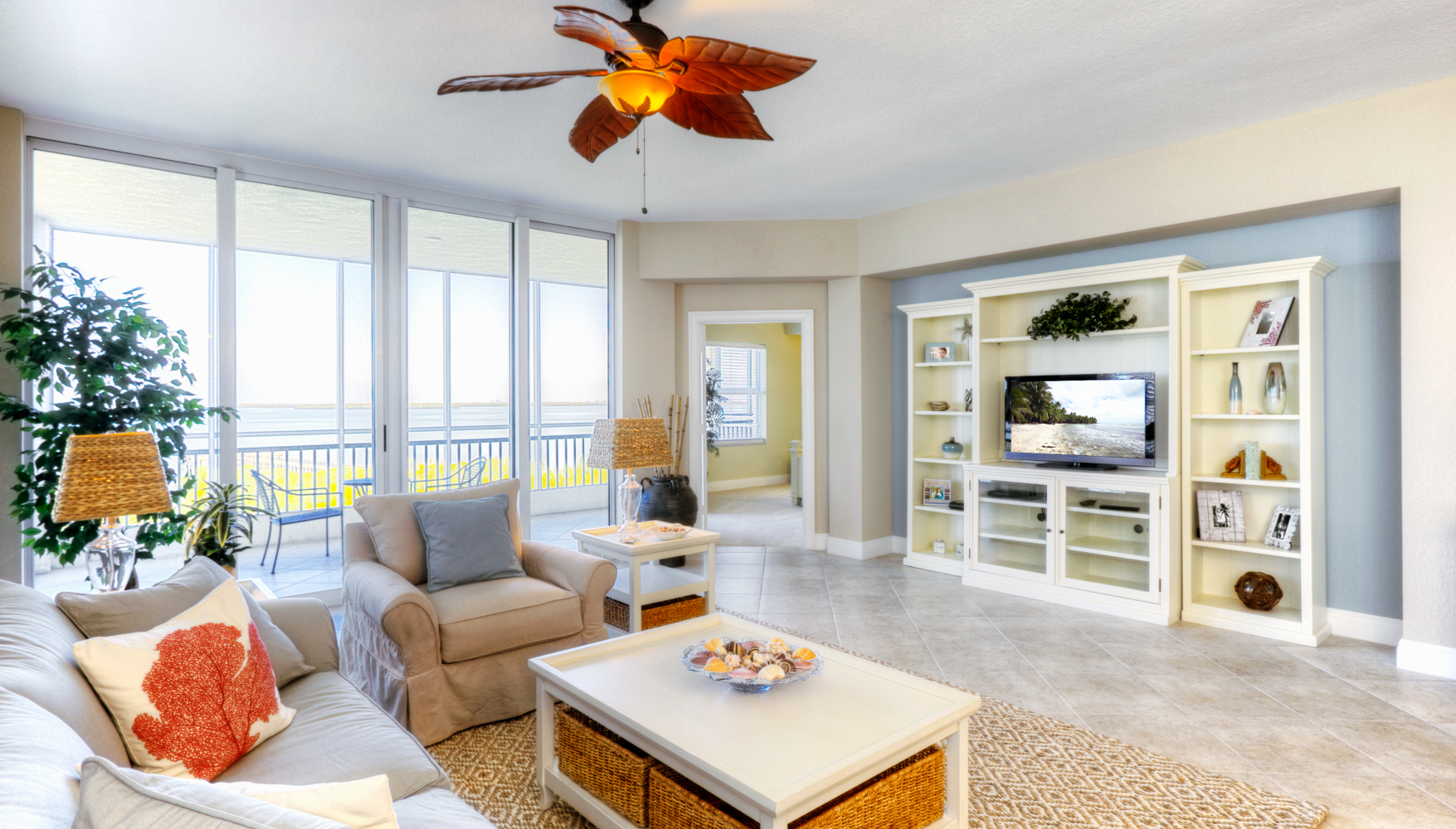 A living room filled with furniture and a ceiling fan.