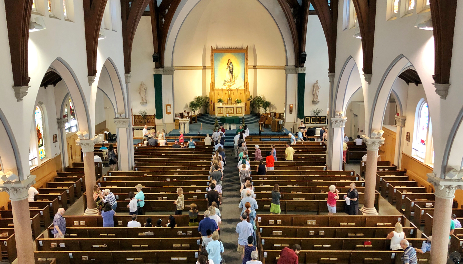 A group of people are standing in a church.