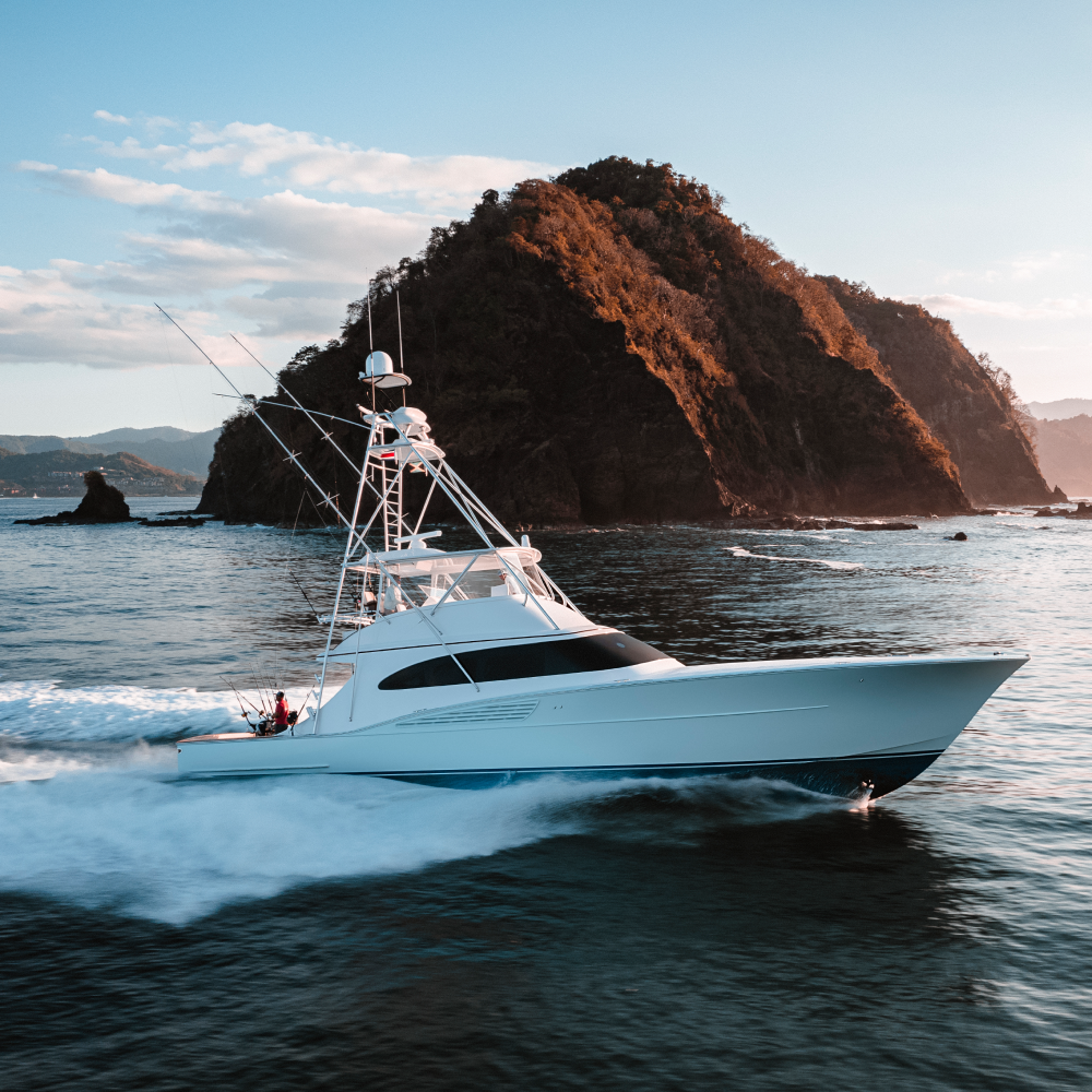A large white boat is floating on top of a body of water