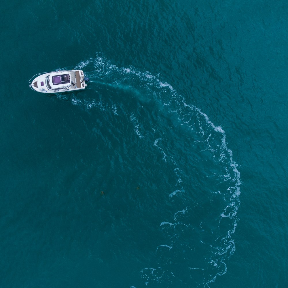 An aerial view of a boat floating on top of a large body of water.