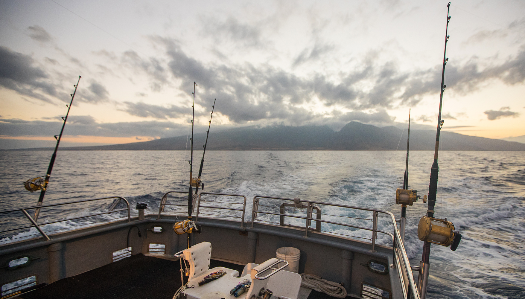 A fishing boat is floating on top of a large body of water.