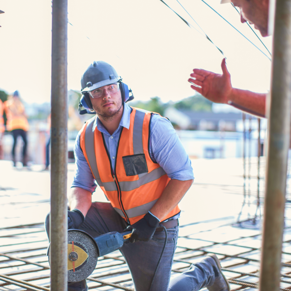A construction worker wearing a hard hat and safety vest