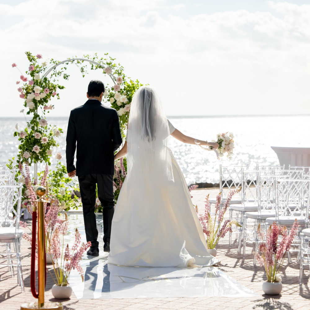 A bride and groom are walking down the aisle at their wedding ceremony.