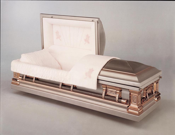 White and silver coffin with an open lid and draped interior, shown on a plain background