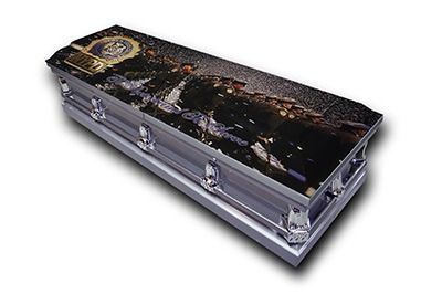 Decorative black coffin with silver handles and a cityscape design on the lid