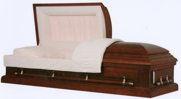 Open casket with white lining on a dark wood base