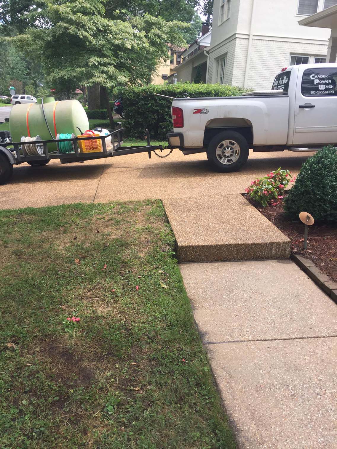 Truck with tank attached on back parked on driveway — Morrilton, AR — Chadek Power Wash
