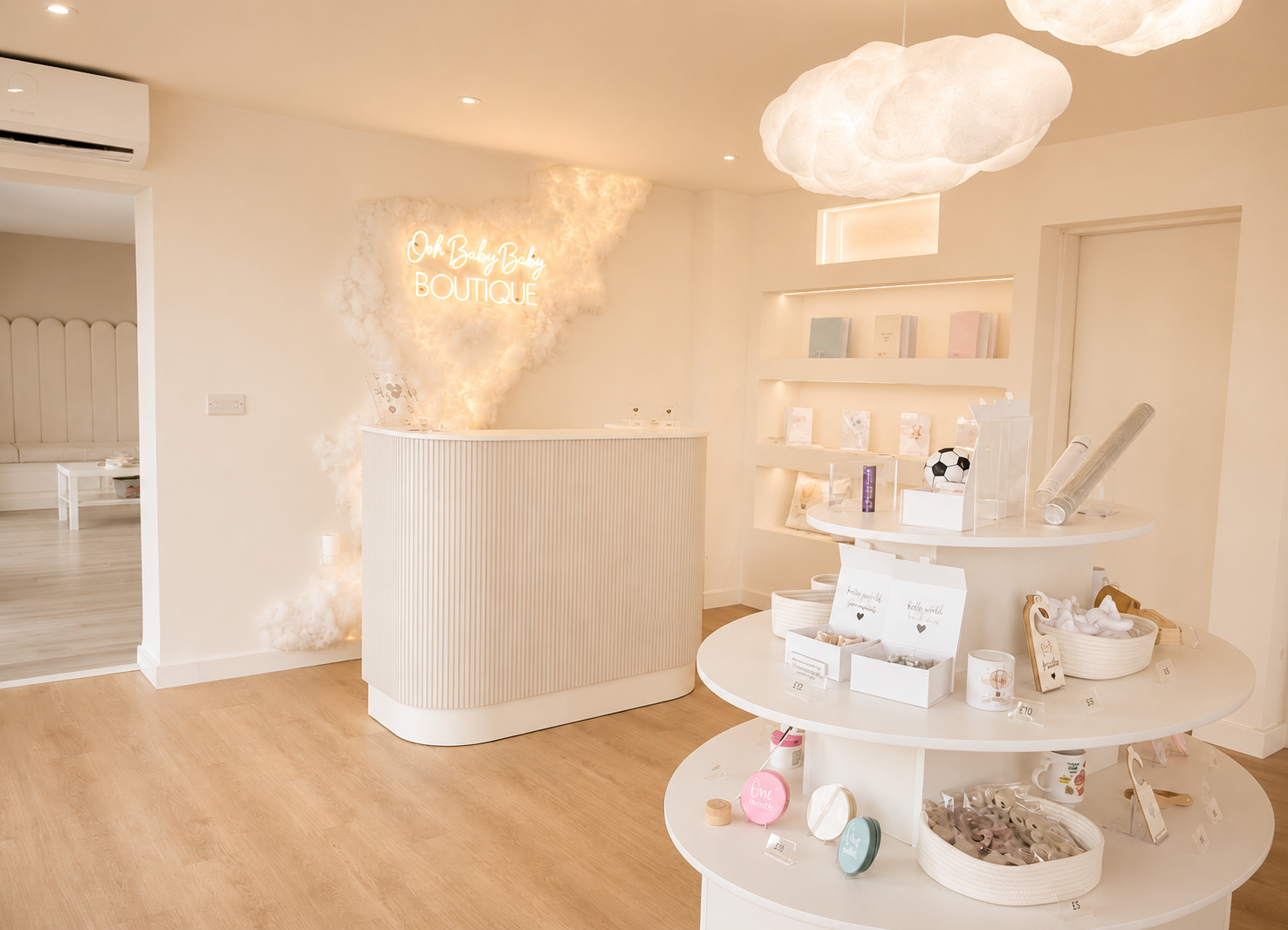 Pastel candy shop interior with white display shelves, pink accents, and warm wood floors