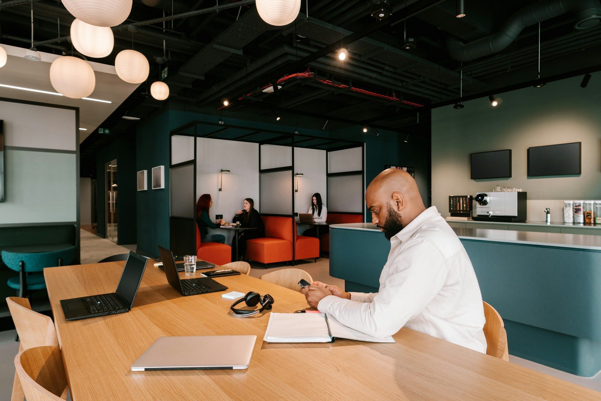 Man looking at his cell phone in an office environment