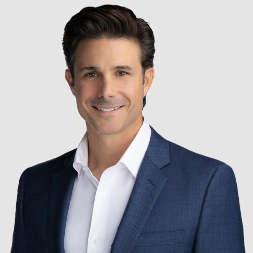 Mark Churella Jr. in a blue blazer and white shirt, smiling, looking at the camera.