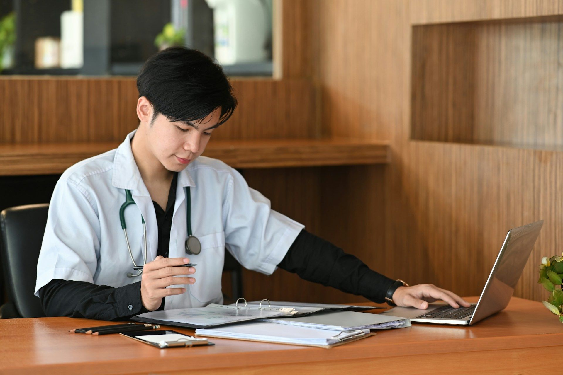 A Doctor reviewing his notes