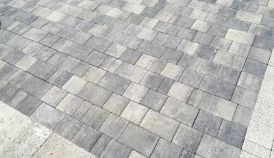Gray stone paver sidewalk with a mottled, irregular pattern