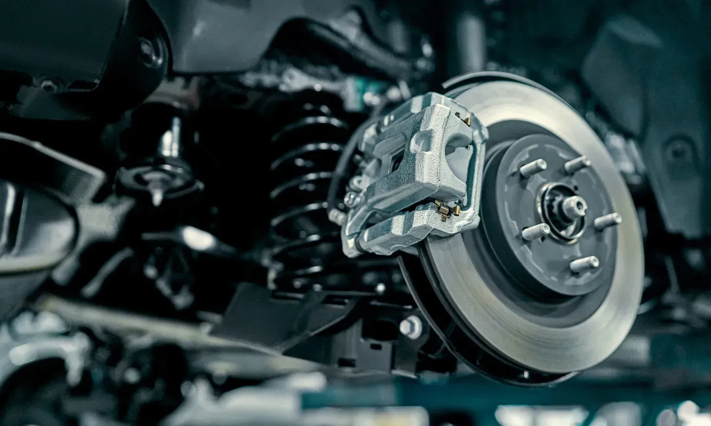 Close-up of a car brake disc and caliper inside a wheel assembly