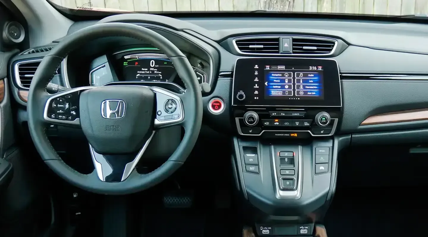 Honda car interior with steering wheel, dashboard display, and center console
