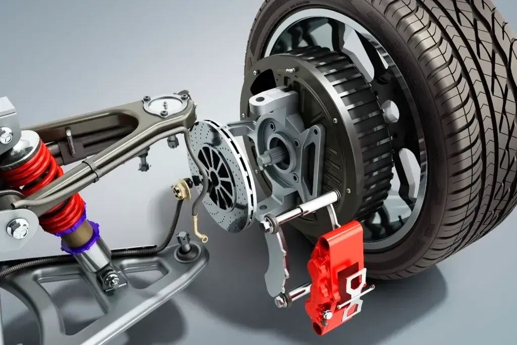 Automobile suspension and disc brake assembly with wheel, axle, and red brake caliper on a cutaway chassis.