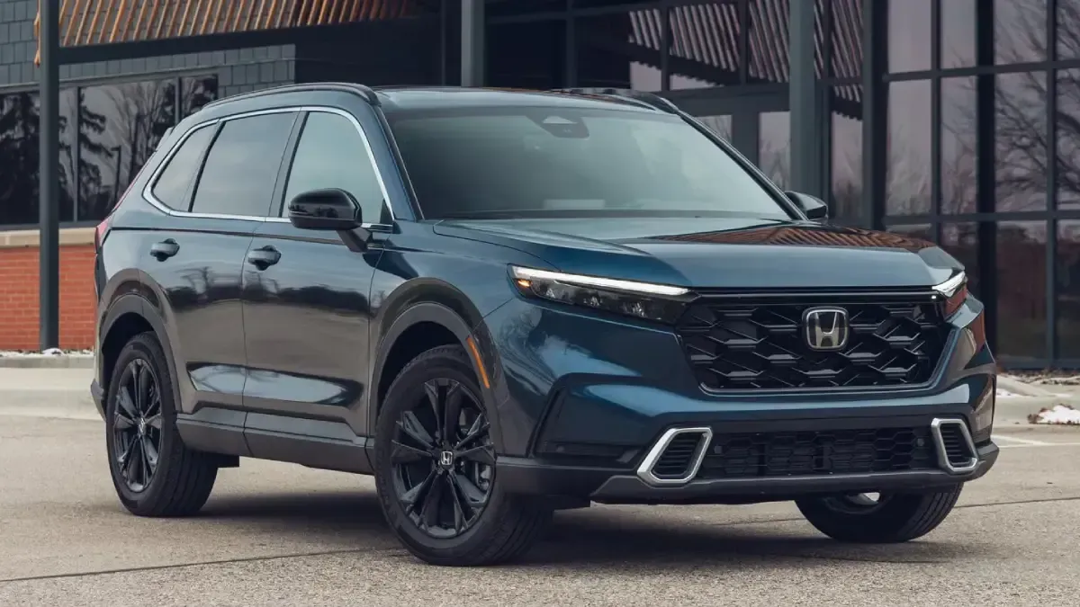 Dark blue SUV parked outside a building, front three-quarter view with black wheels.
