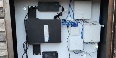A white box with a lot of wires coming out of it.