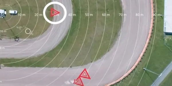 An aerial view of a race track with a red triangle in the middle.