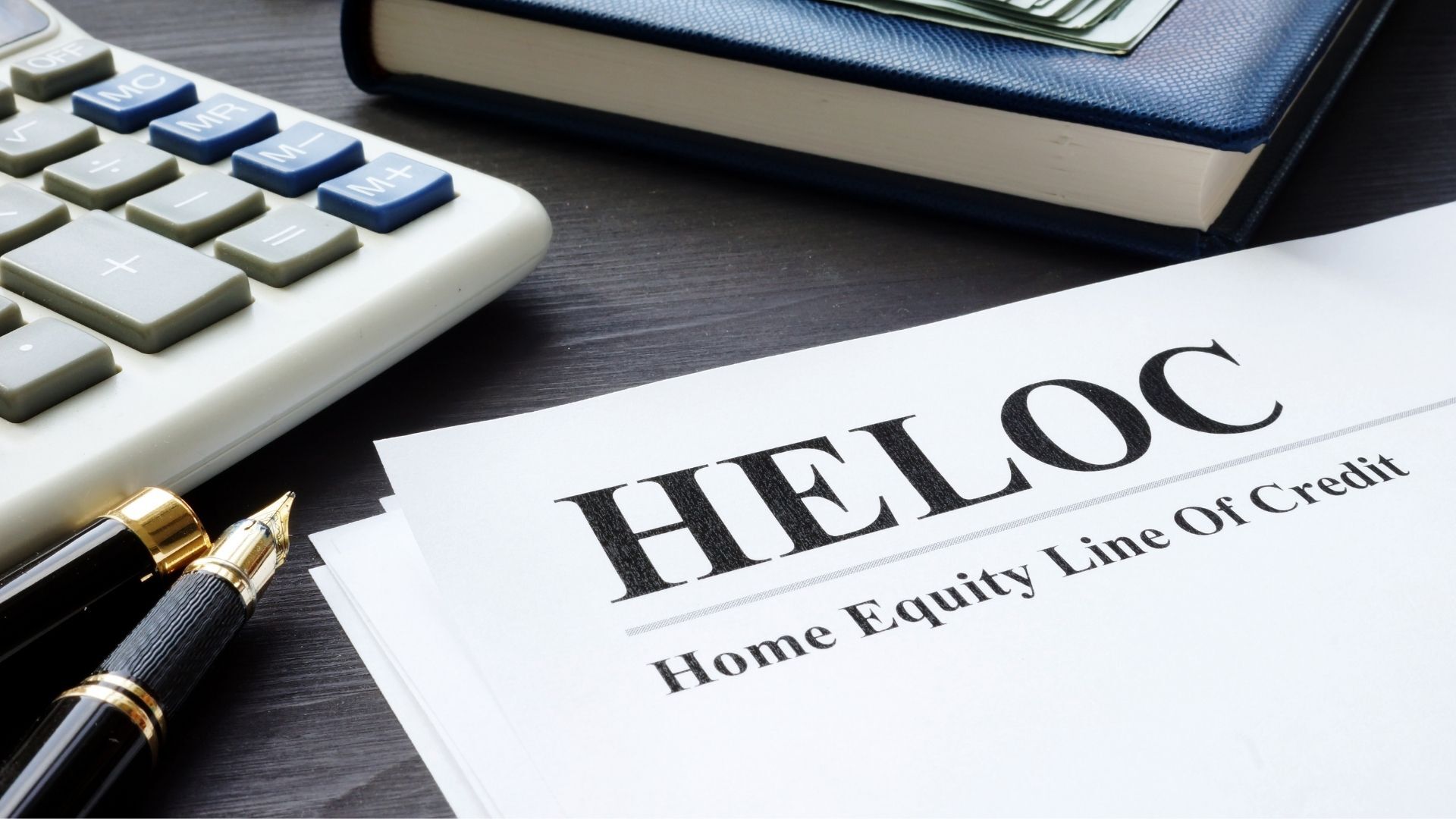 A pen is sitting on top of a piece of paper that says heloc home equity line of credit.