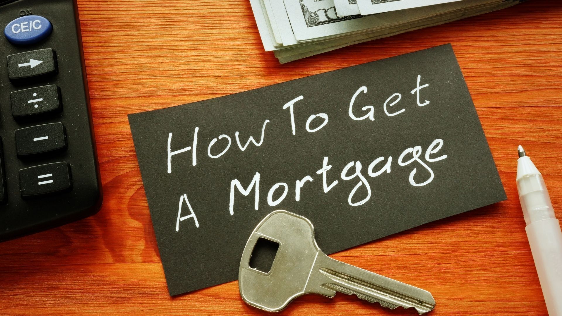 A chalkboard with the words how to get a mortgage written on it