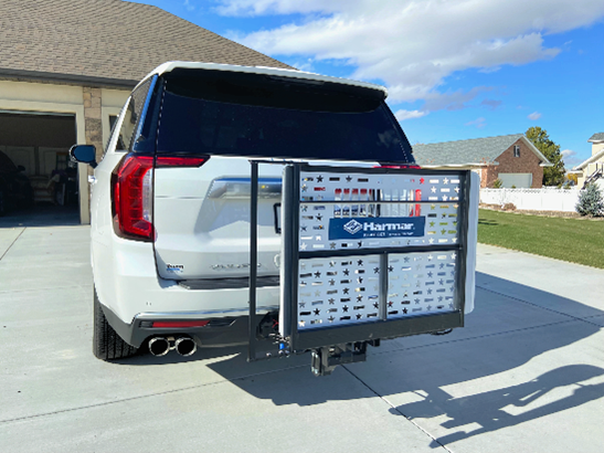 A white can with a Mobility Device Lift in the back.