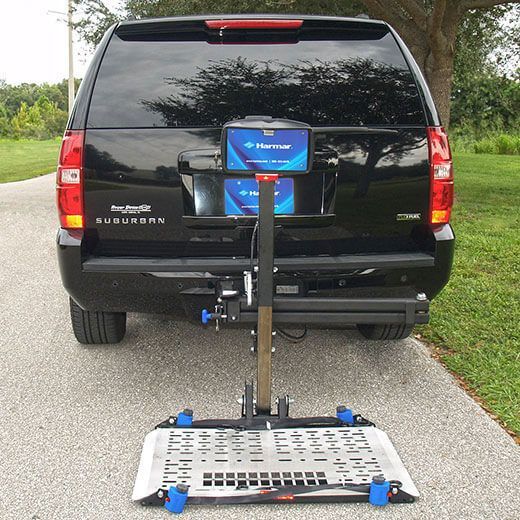 A black SUV with a lift attached to the back of it