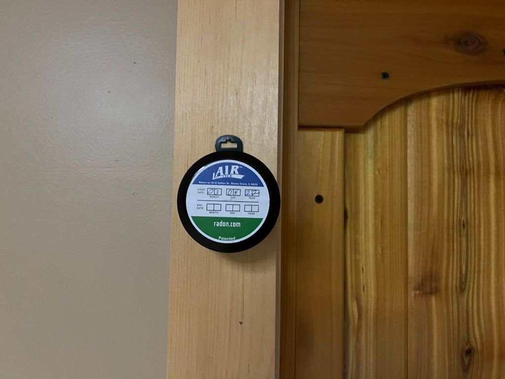A Round Object is Hanging on a Wooden Door.
