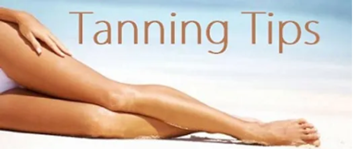 Woman's legs on a beach with Tanning Tips displayed above the legs for Fit n Tan St. Louis tips on tanning beds.