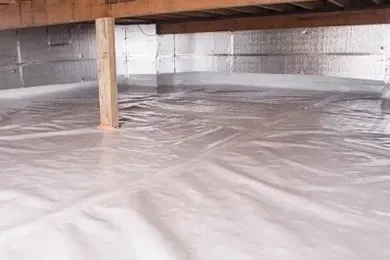 Crawlspace under a wooden floor, flooded with standing water and insulated ducting overhead