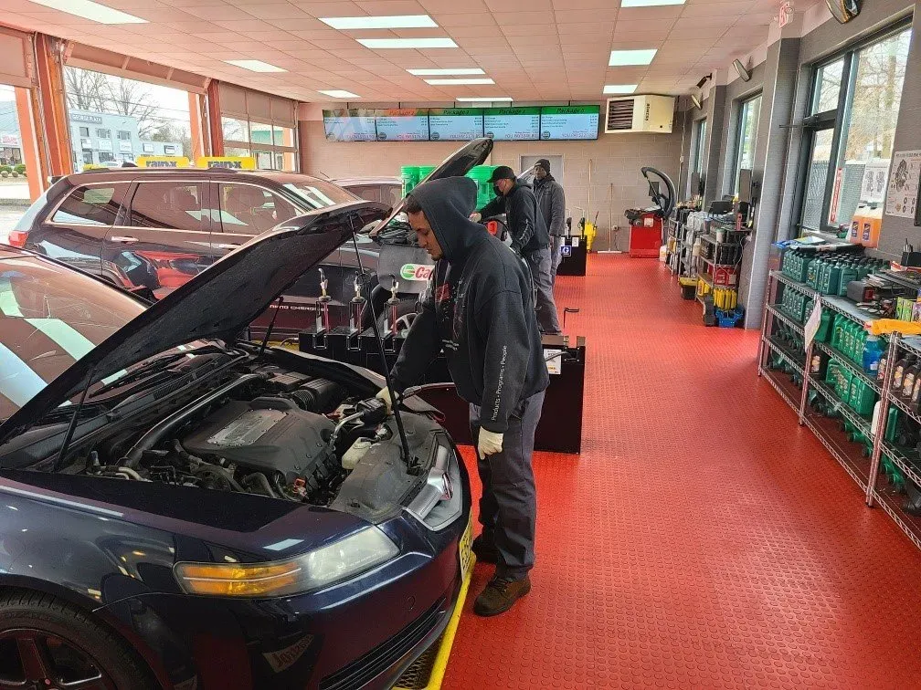 Mechanics working on vehicles at our Colonia auto repair shop