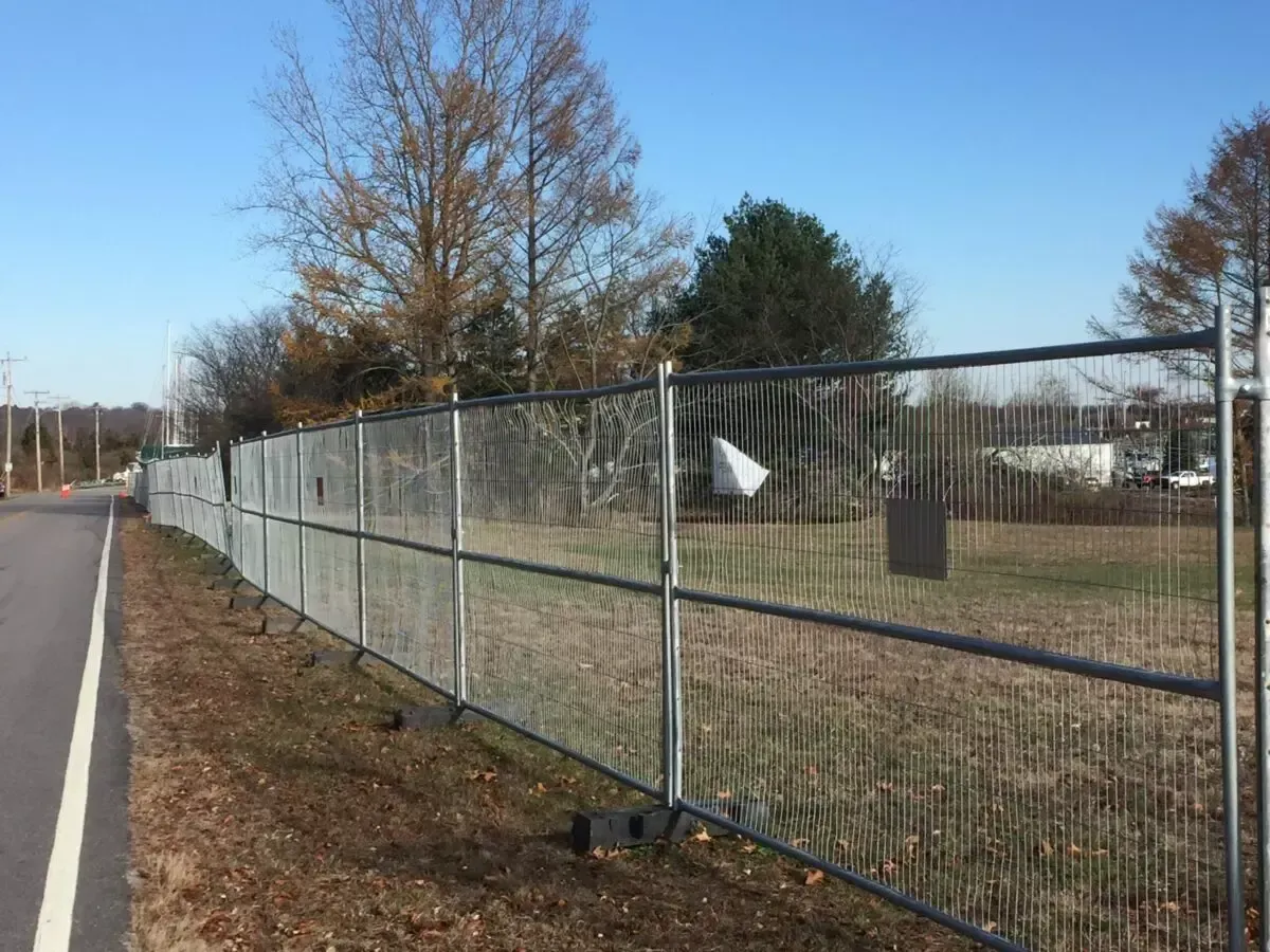 A fence is along the side of a road.