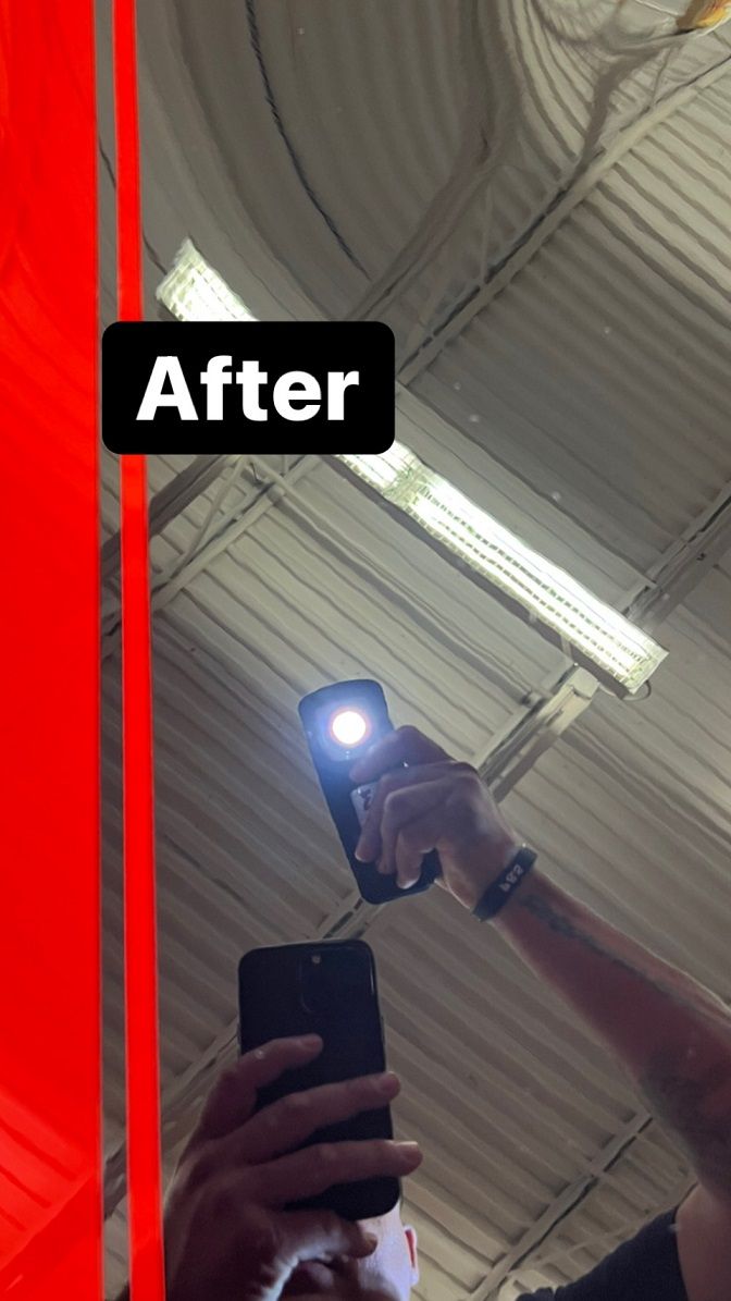 Person holding phone with flashlight pointed towards a metal ceiling, labeled 