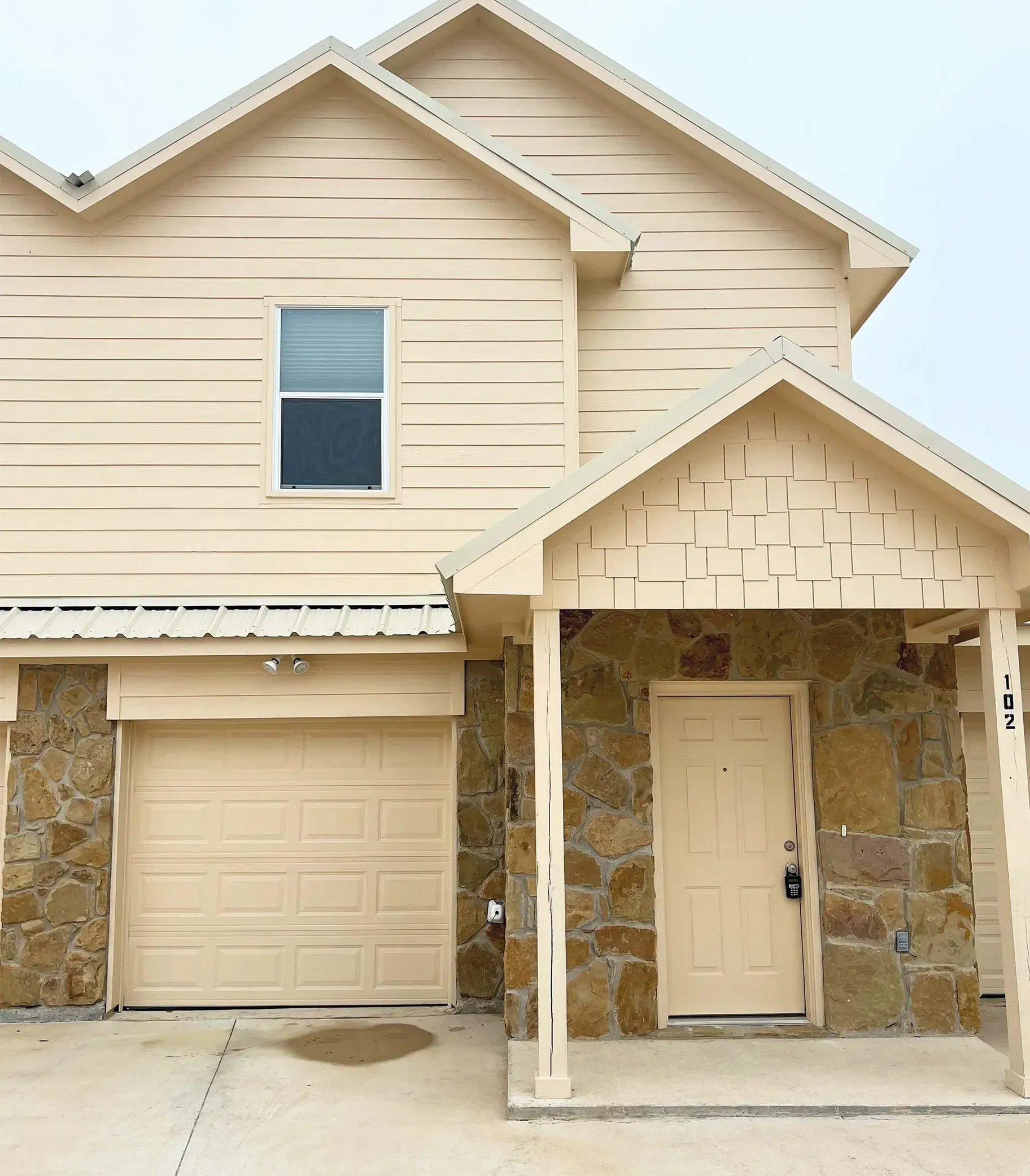 A house with a porch and a garage door