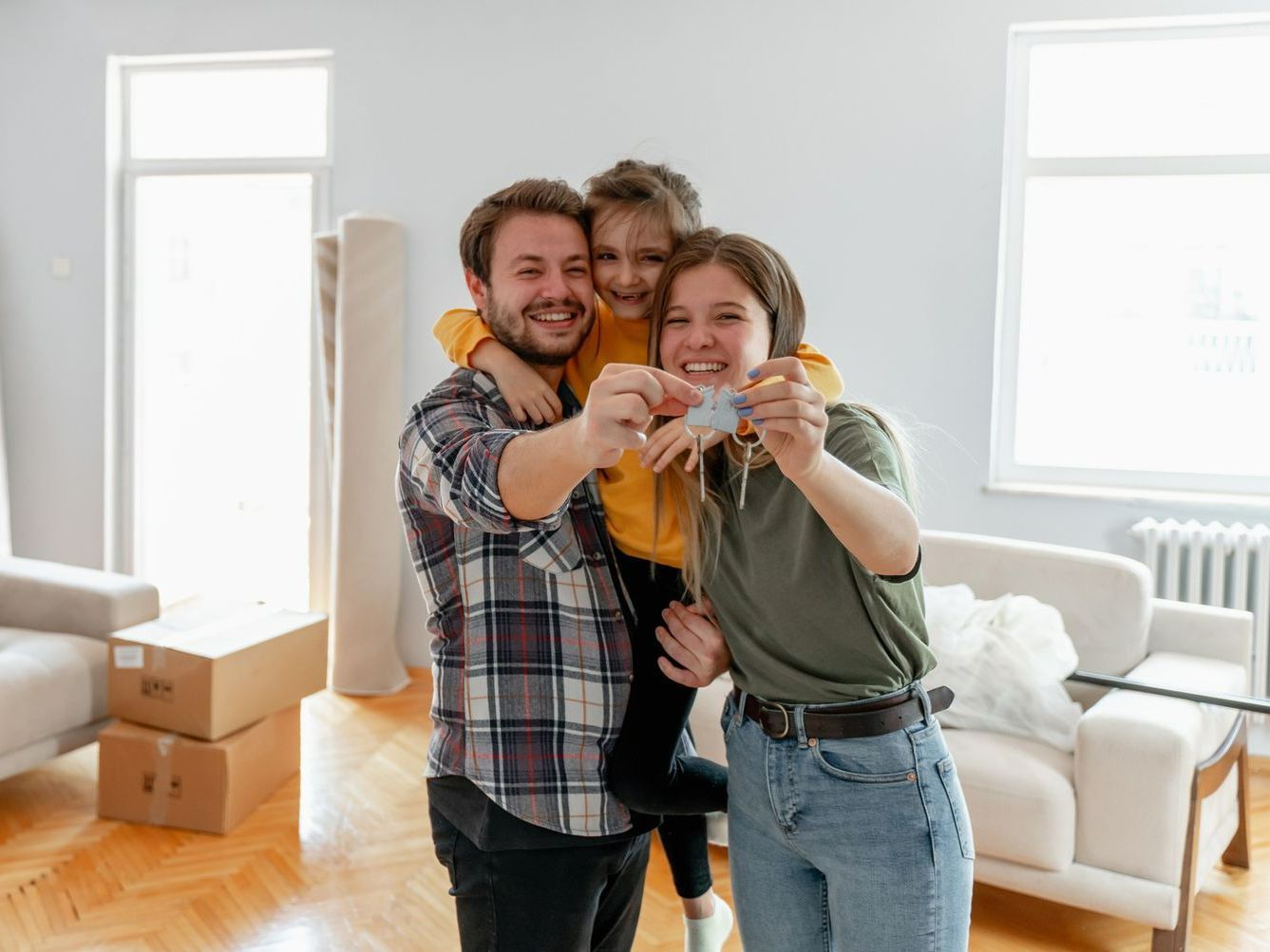 A family is taking a selfie in their new home.