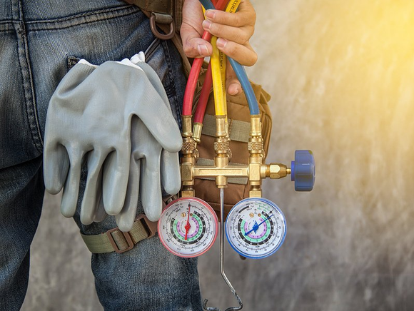 AC repair man holding Tools