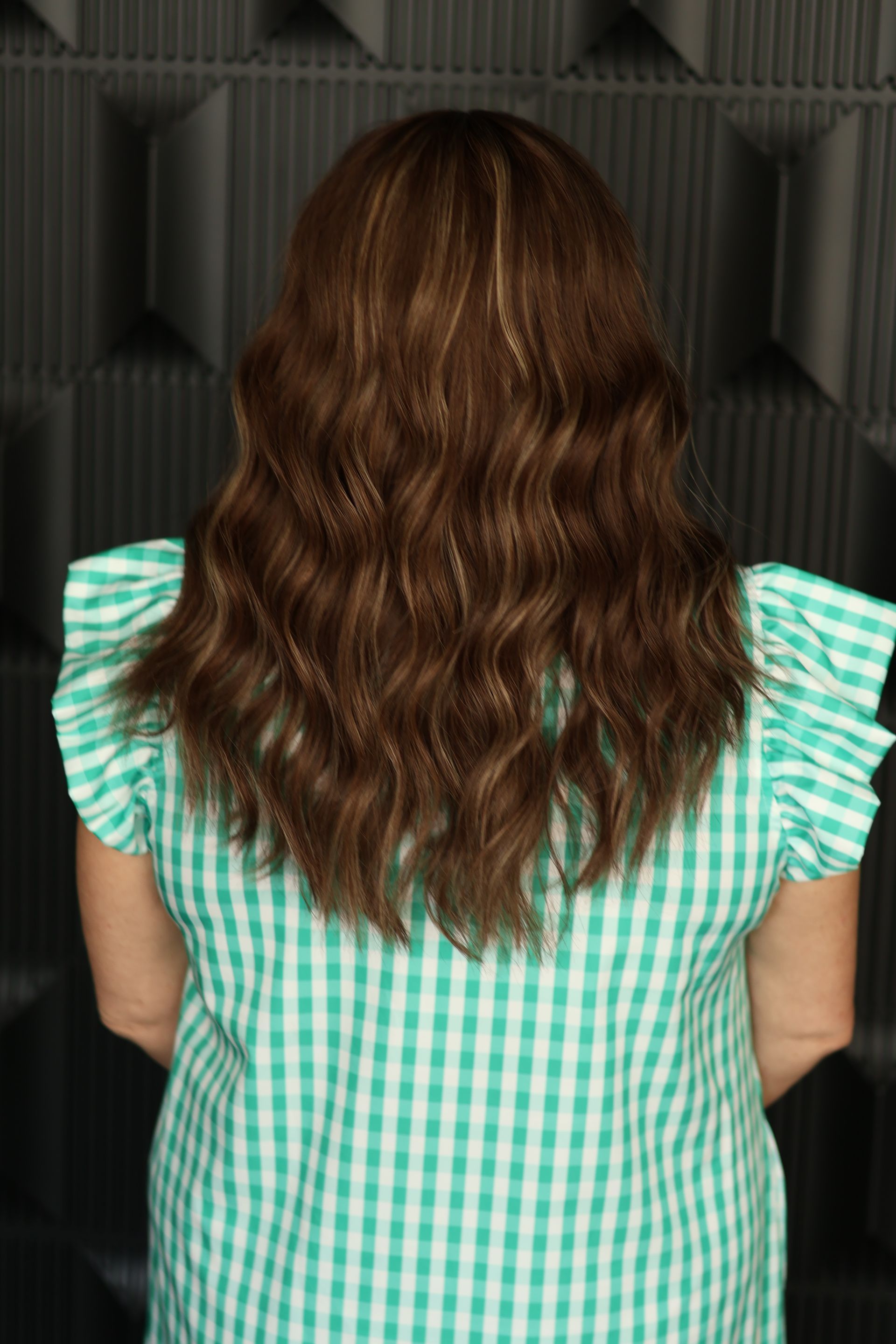 Back view of finished custom wig showing color, movement, and waves