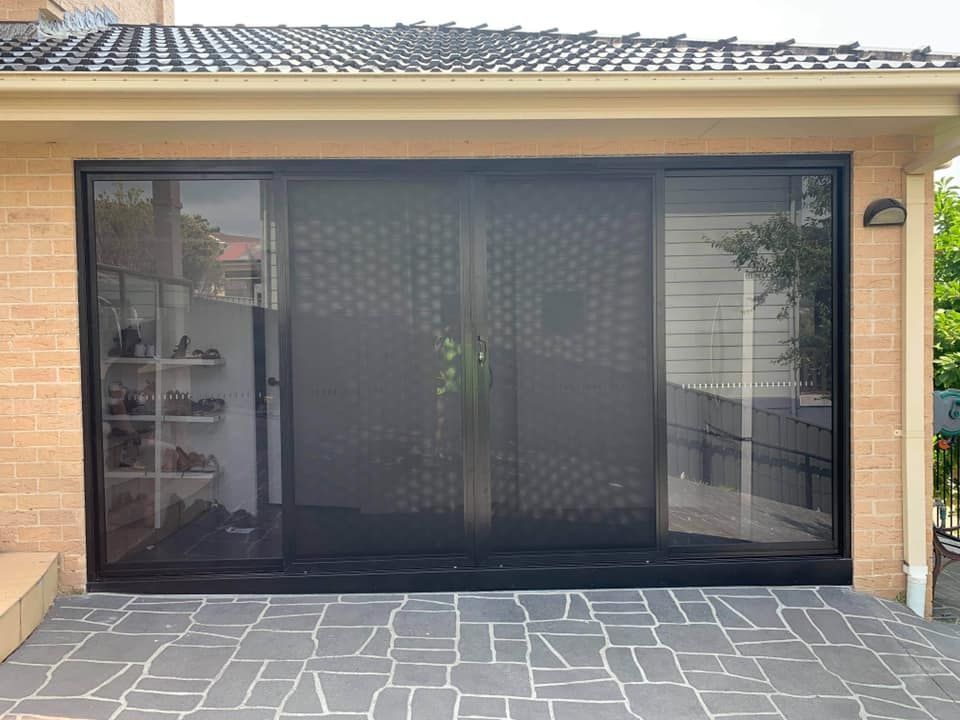 A House with A Sliding Glass Door and A Brick Wall — Distinctive Glass & Aluminium in Port Kembla, NSW