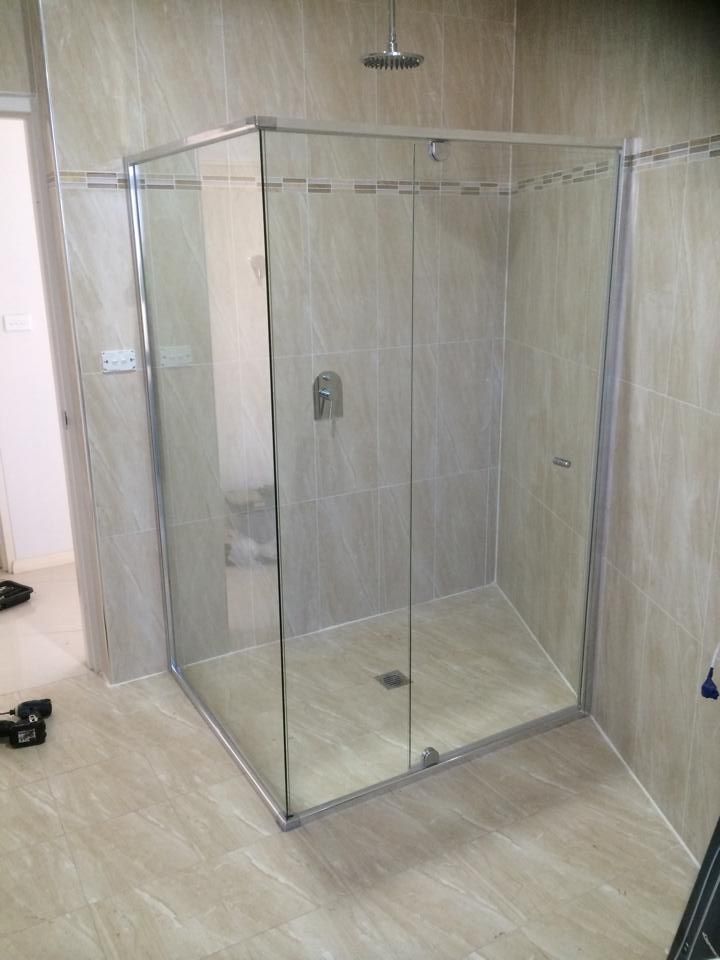 A Bathroom with A Walk in Shower with Sliding Glass Doors — Distinctive Glass & Aluminium in Port Kembla, NSW