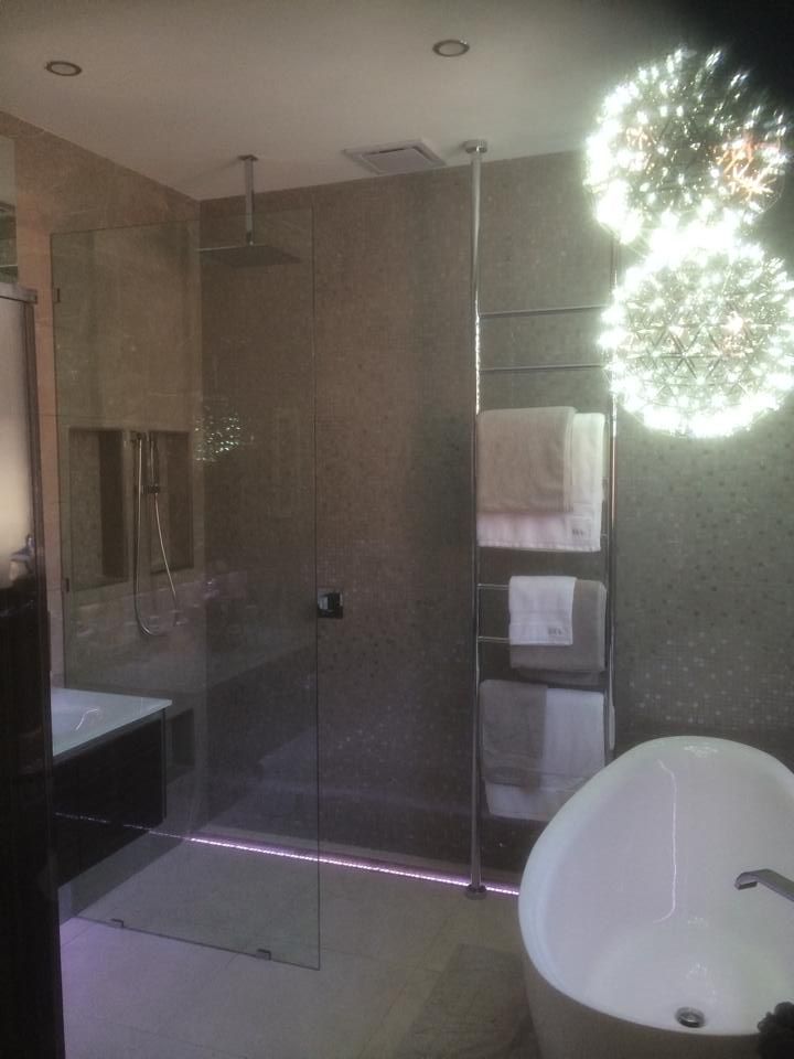 A Bathroom with A Bathtub, Sink and Mirror — Distinctive Glass & Aluminium in Port Kembla, NSW