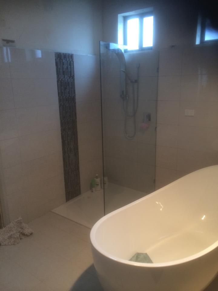 A Bathroom with A Bathtub and A Shower Stall — Distinctive Glass & Aluminium in Port Kembla, NSW