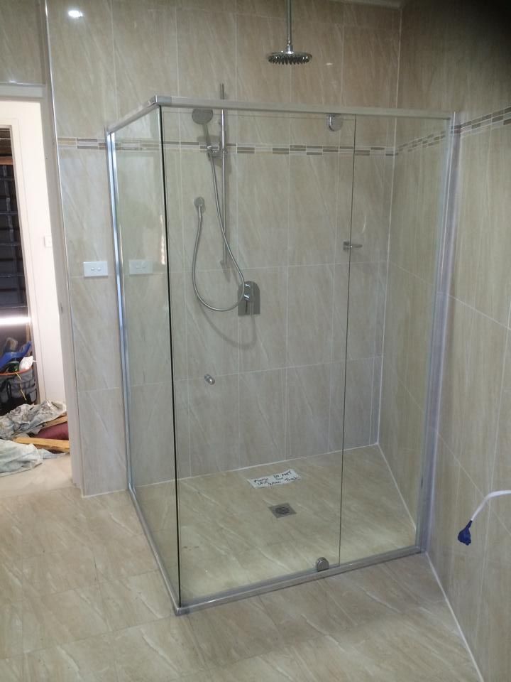 A Bathroom with A Walk in Shower with Sliding Glass Doors — Distinctive Glass & Aluminium in Port Kembla, NSW