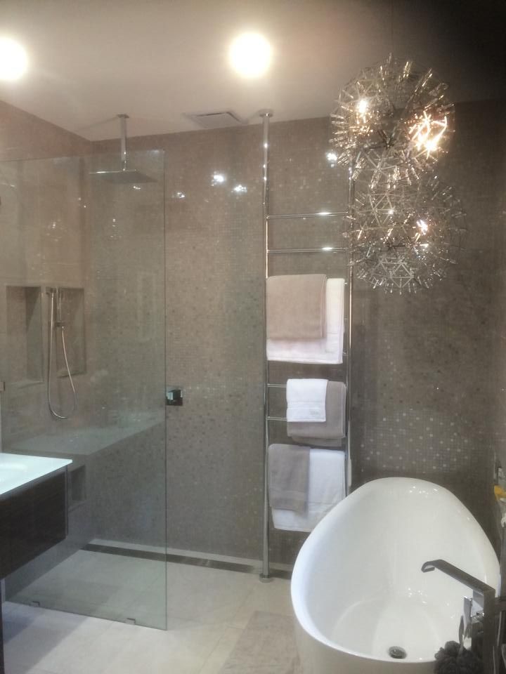 A Bathroom with A Bathtub and Chandelier — Distinctive Glass & Aluminium in Port Kembla, NSW