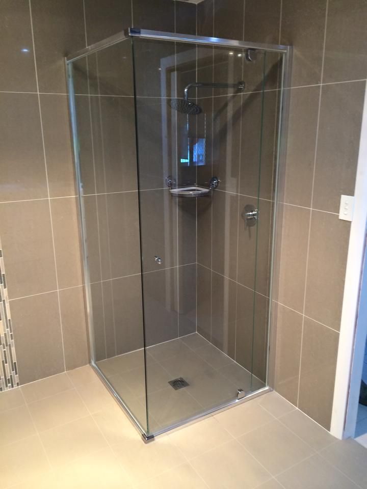 A Bathroom with A Shower Stall with Sliding Glass Doors — Distinctive Glass & Aluminium in Port Kembla, NSW