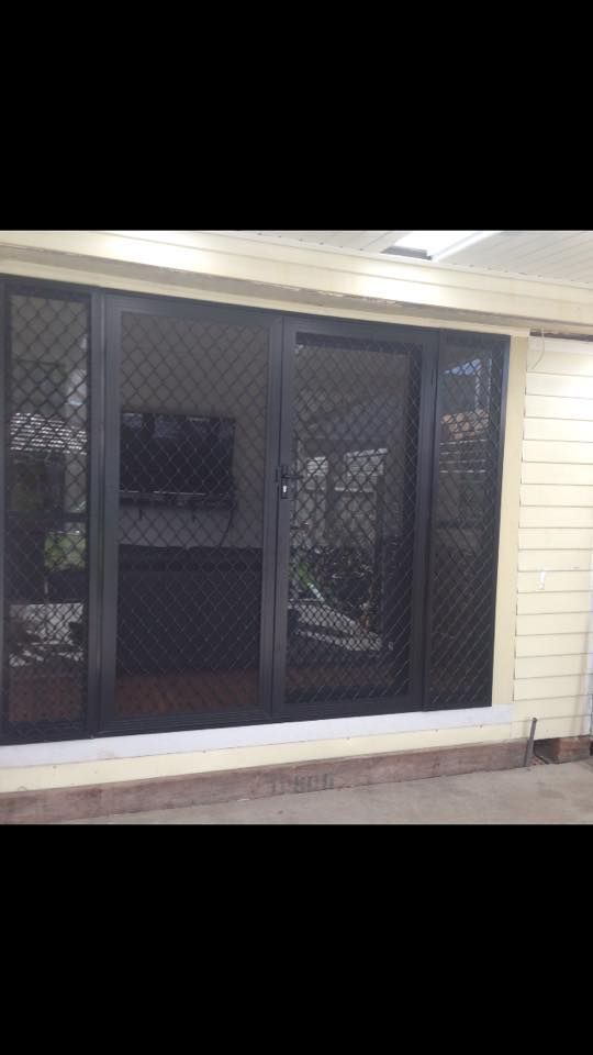 A Living Room with A Sliding Glass Door — Distinctive Glass & Aluminium in Port Kembla, NSW