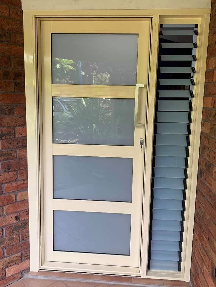 A White Door with Shutters on The Side of It — Distinctive Glass & Aluminium in Port Kembla, NSW