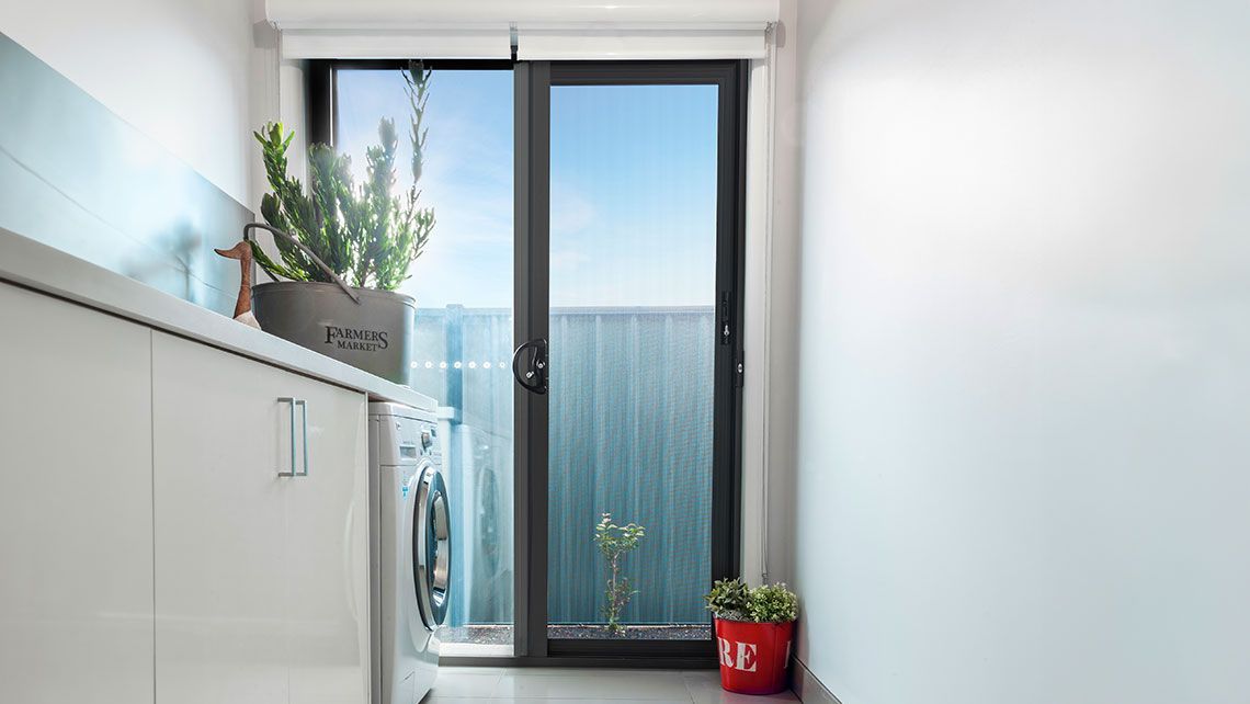 A Laundry Room with A Washing Machine — Distinctive Glass & Aluminium in Port Kembla, NSW