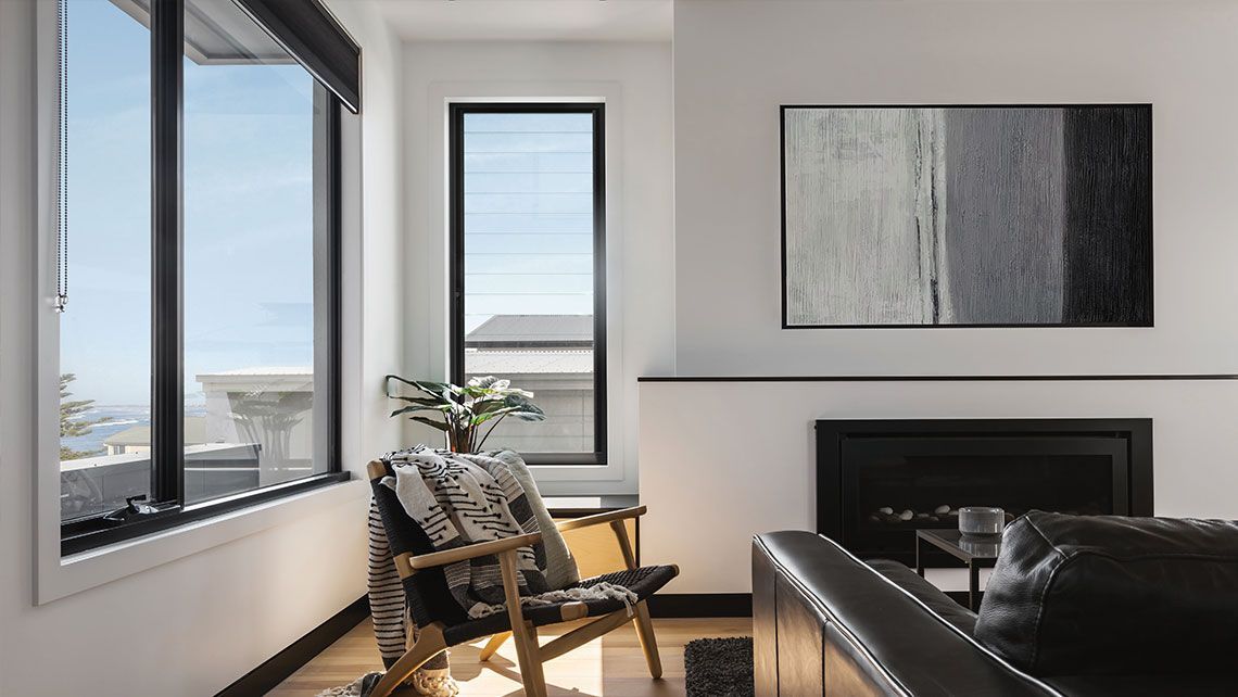 A Living Room with A Couch and Painting on The Wall — Distinctive Glass & Aluminium in Port Kembla, NSW