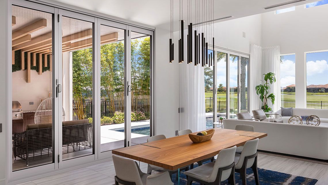 A Dining Room with A Wooden Table and Chairs — Distinctive Glass & Aluminium in Port Kembla, NSW