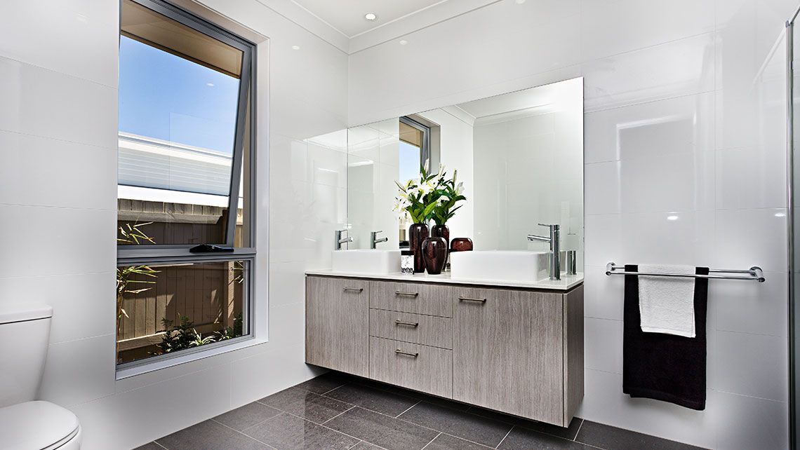 A Bathroom with Two Sinks and A Window — Distinctive Glass & Aluminium in Port Kembla, NSW